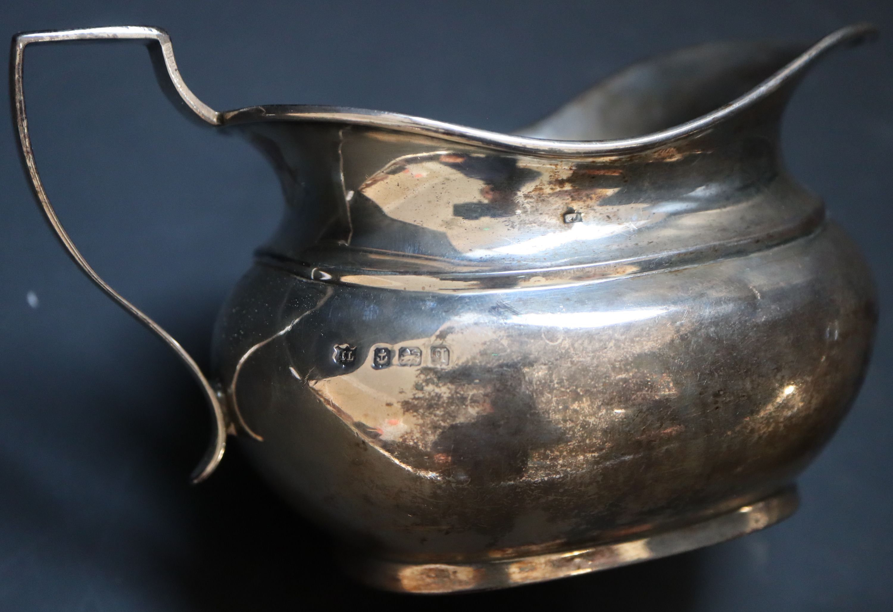 An Edwardian silver sauceboat, Chester, 1905 and a George V cream jug, gross 8oz.